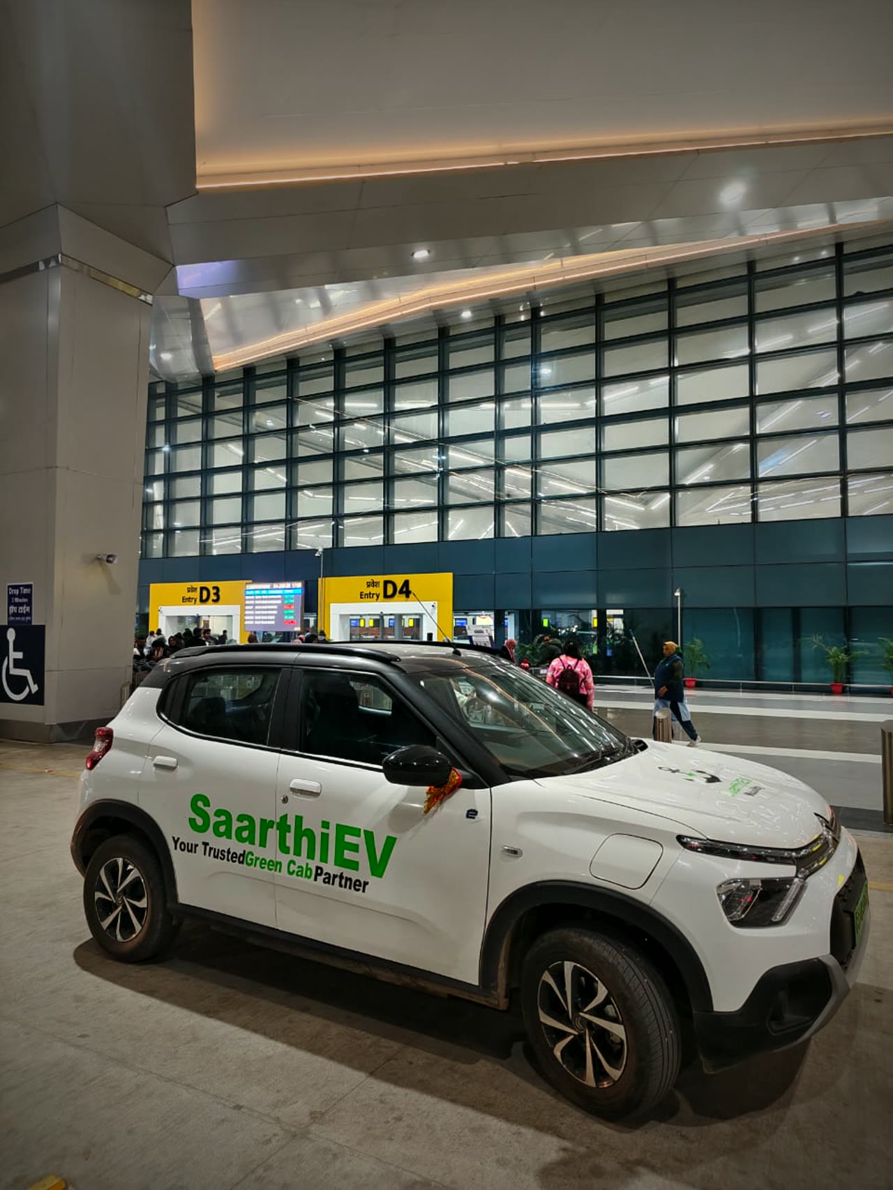 A SaarthiEV cab at Patna's Jay Prakash Narayan Airport terminal at night